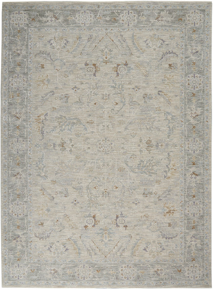 Distressed light-gray oriental rug with pale blue and beige florals and ornate border.