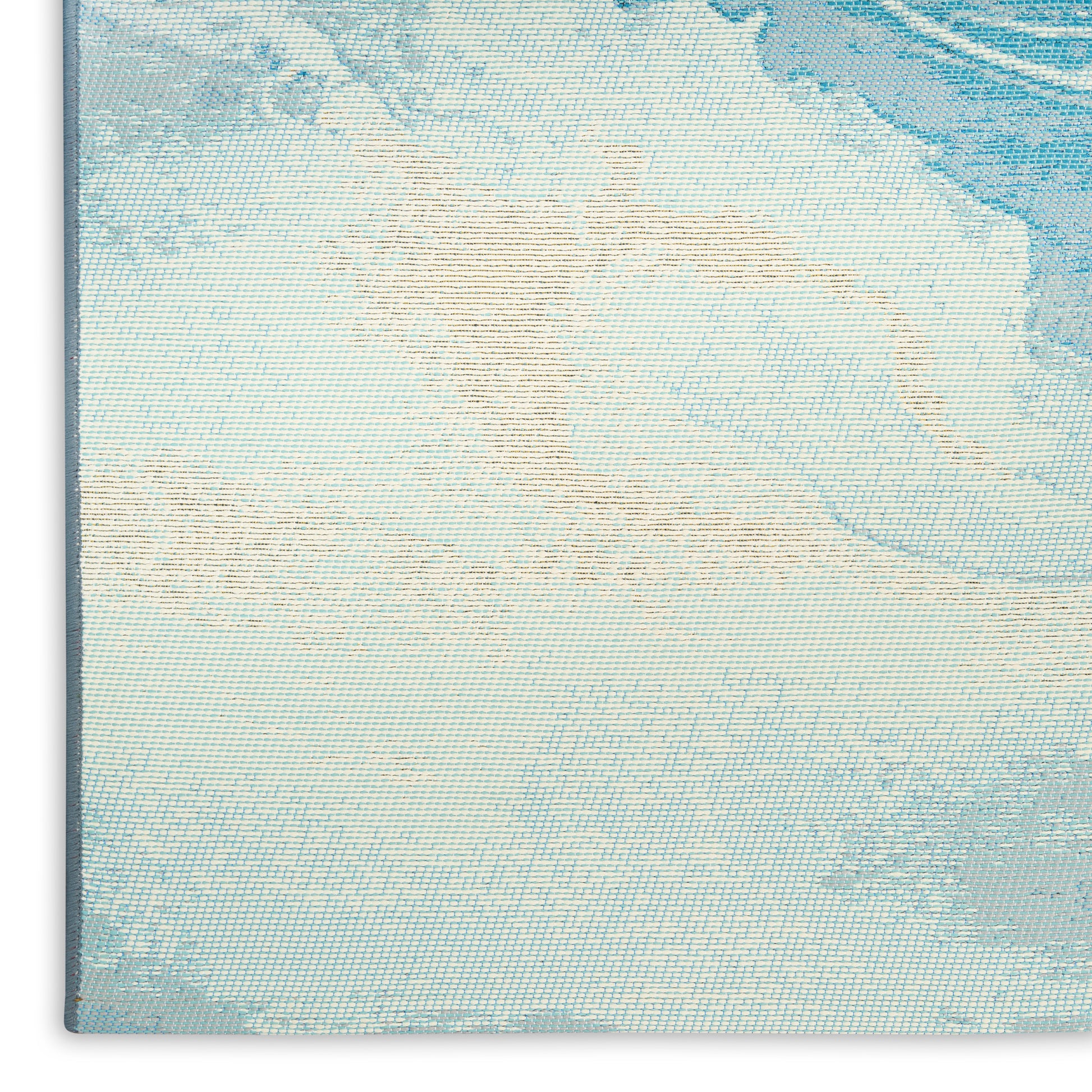 Close-up of pale blue woven tapestry with subtle beige pattern; decorative wall art, canvas texture.