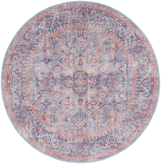 Round oriental rug in pastel blues and pinks with intricate floral medallion and border.