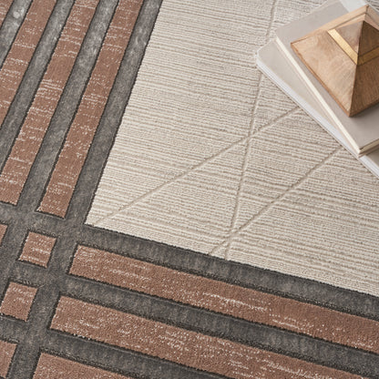 Beige rug with brown and charcoal geometric grid; stack of books and a wooden geometric pyramid sculpture in corner.
