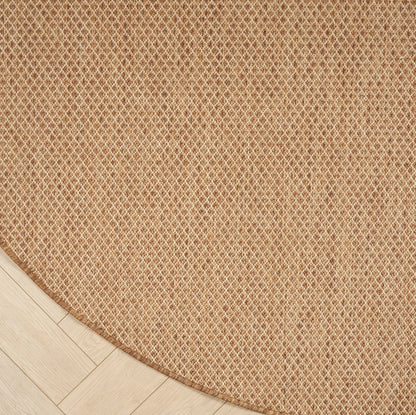 Round natural jute rug with a tight woven lattice pattern in warm beige on light wood flooring.