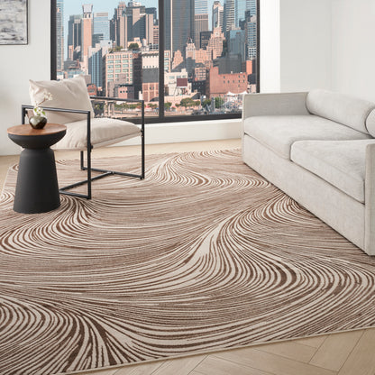 Living room with a beige-brown swirl rug, light gray sofa, black-frame chair, round side table, city skyline view.