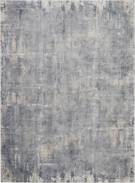 Blue-gray distressed abstract rug with beige patches; modern, worn-texture pattern for living spaces.