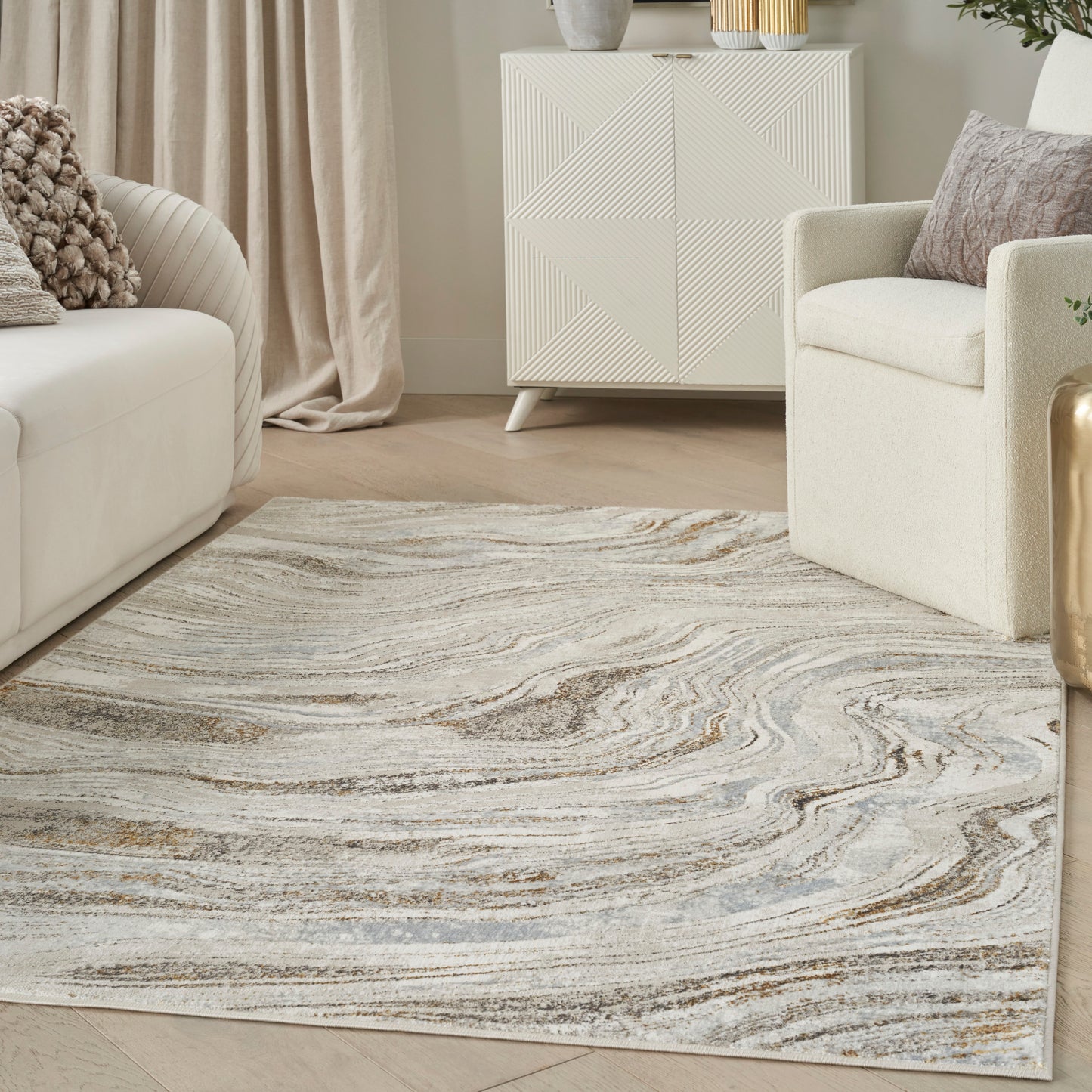 Neutral swirl-pattern area rug in gray, beige and taupe; soft pile in a contemporary living room with cream sofa.