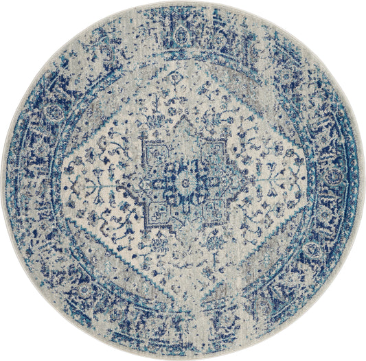 Round distressed blue oriental rug with intricate central medallion and patterned border.