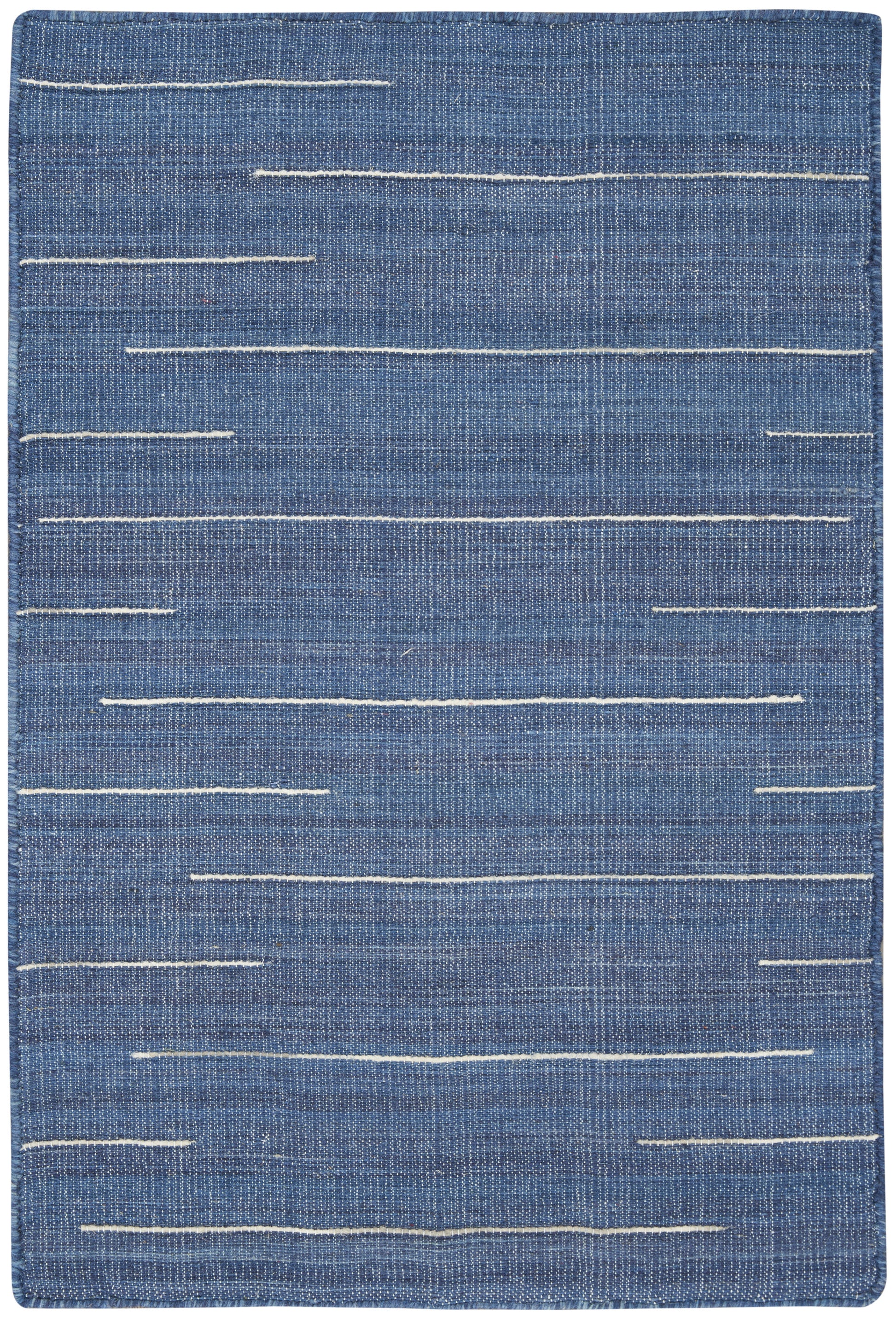Blue denim-style rug with irregular white stitch lines, rectangular, casual modern decor.