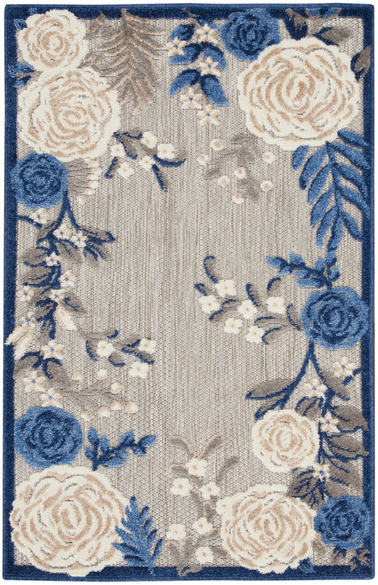 Beige floral area rug with blue and cream roses, gray leaves, and a navy border.