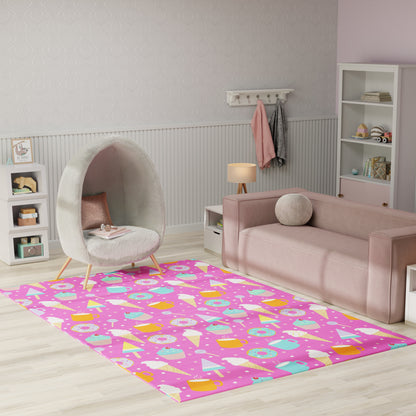 Pink kids' rug with pastel donuts and ice-cream cones; playful room with an egg chair and pink sofa.