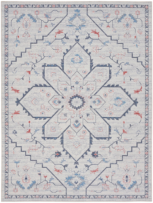 Light gray-blue oriental rug with a bold navy central star medallion, pale blue and coral floral accents, rectangular.