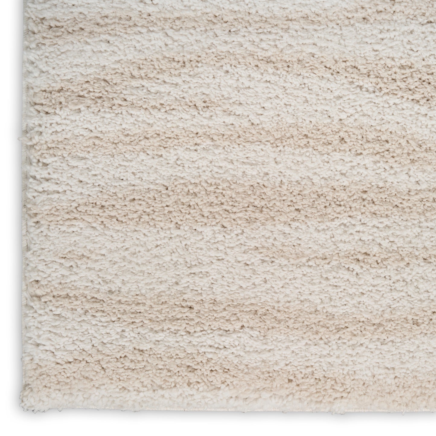 Beige cream high-pile shag rug with soft fluffy fibers; close-up texture.