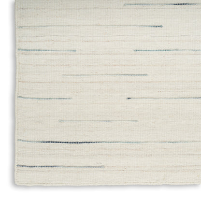 Ivory woven rug with subtle blue-gray horizontal lines; soft textured, modern minimalist style.
