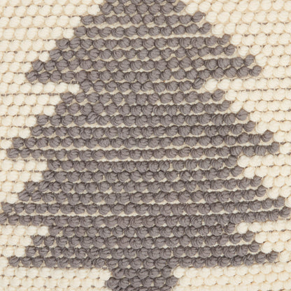 Cream woven rug with charcoal tree silhouette in chunky looped tuft texture.