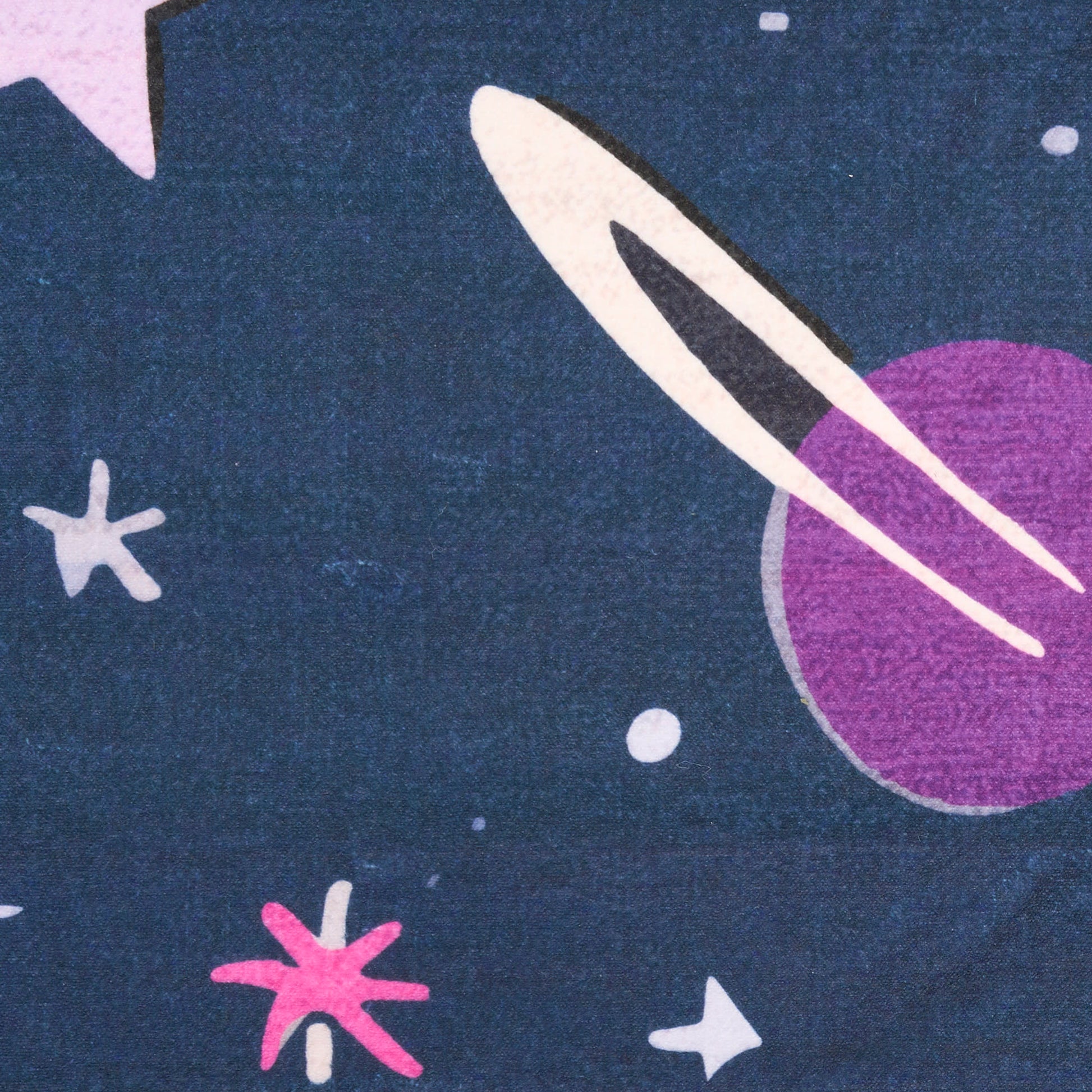 Dark blue space-pattern rug with pink starbursts, white stars, and a purple planet with a white ring.
