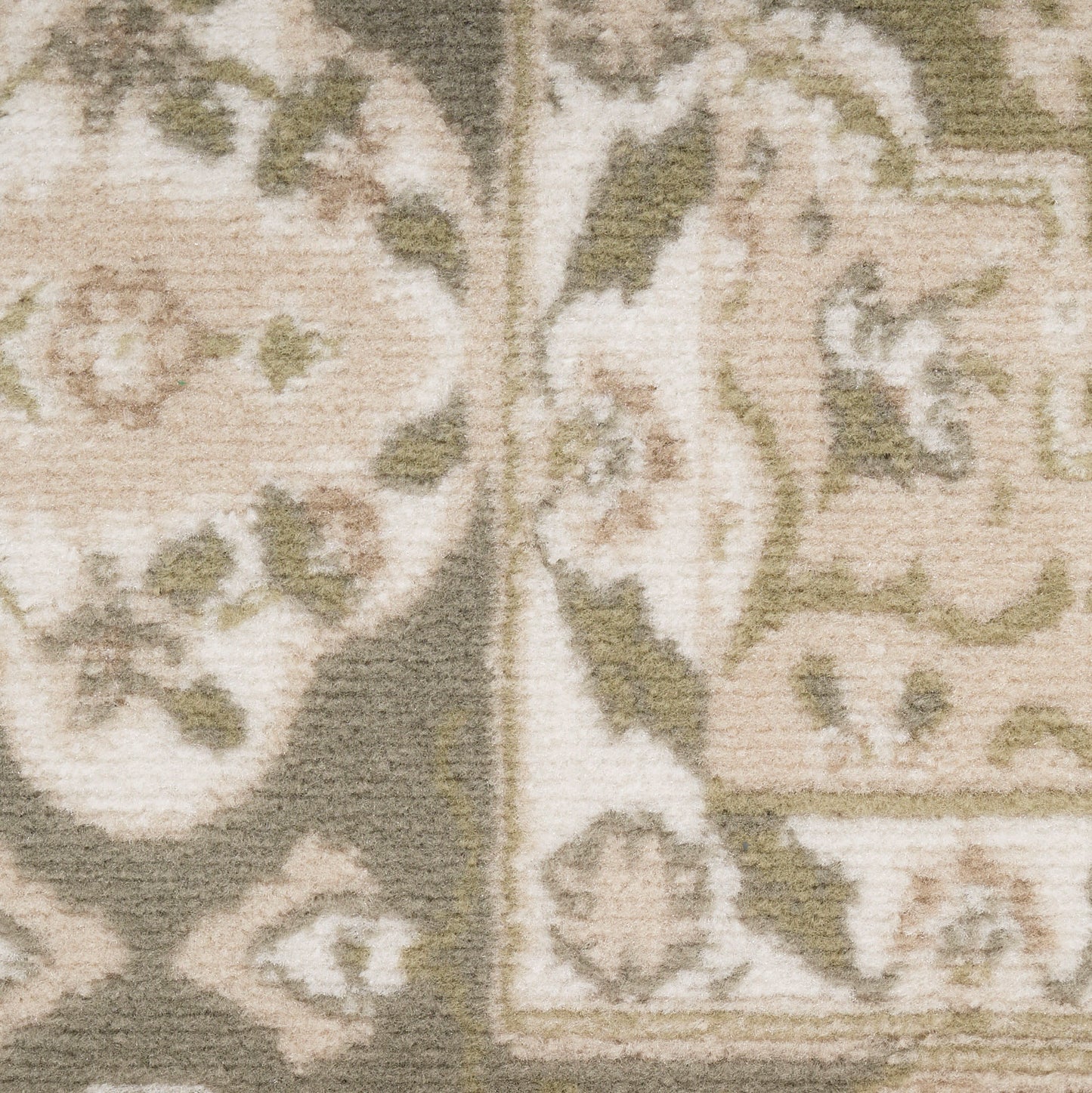 Close-up of a beige and taupe rug with damask/medallion motifs and a textured woven surface.