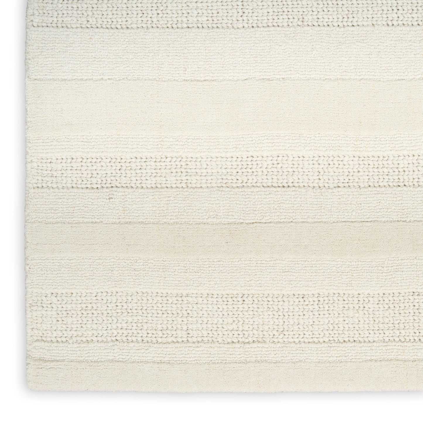 Cream striped woven rug with horizontal textured bands; soft neutral bath mat style for home decor.