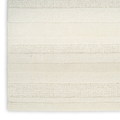 Cream striped woven rug with horizontal textured bands; soft neutral bath mat style for home decor.