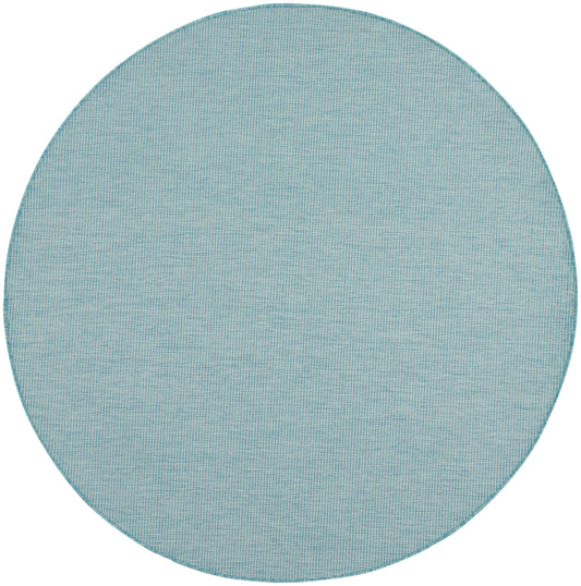 Round teal woven rug with grid texture and subtle stitched edge.