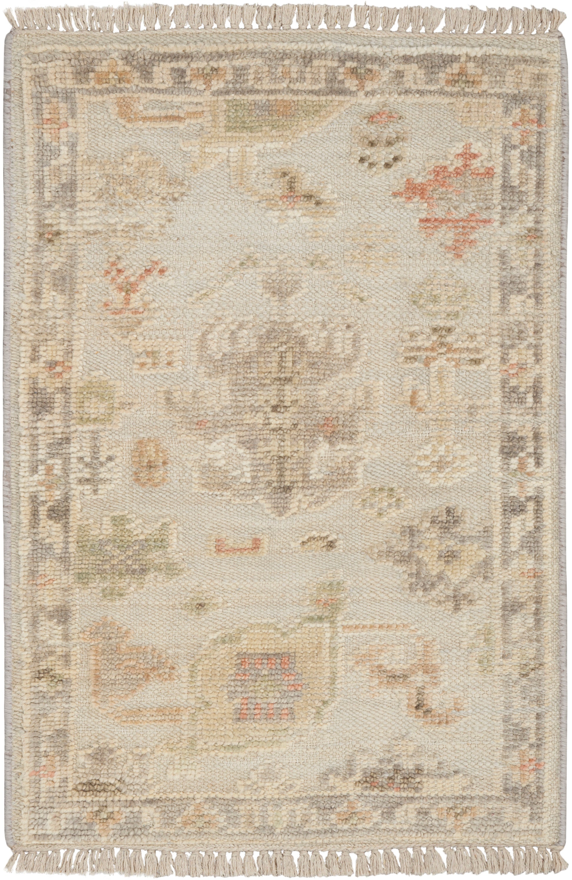 Rectangular cream-toned oriental rug with faded pastel medallion, floral motifs, and fringed ends; vintage-inspired decor.