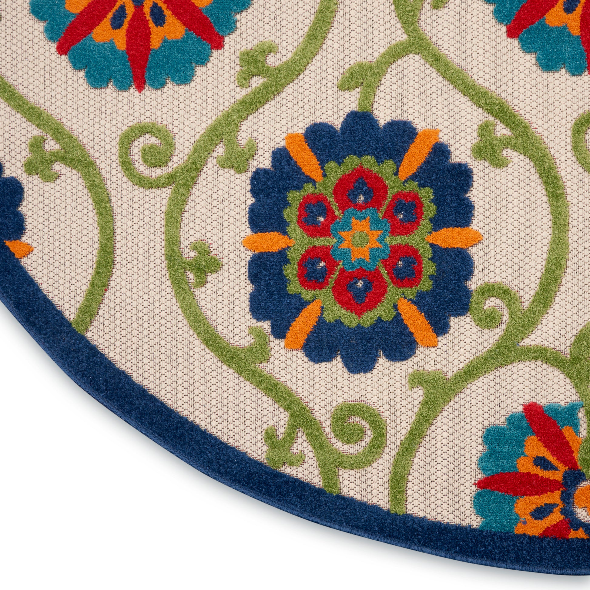 Round rug with cream background, blue border, bright floral medallions in blue, orange, red, and green vines.
