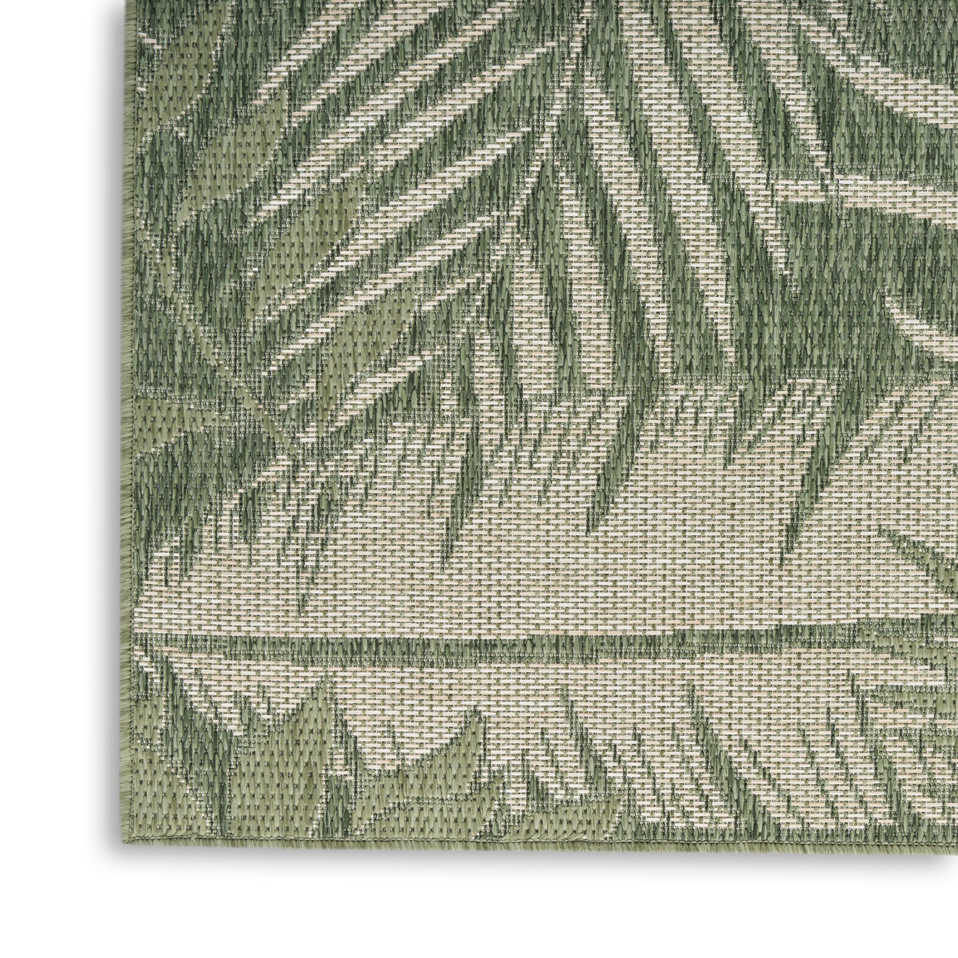 Woven green palm leaf patterned rug in olive and beige with textured weave and visible edge.