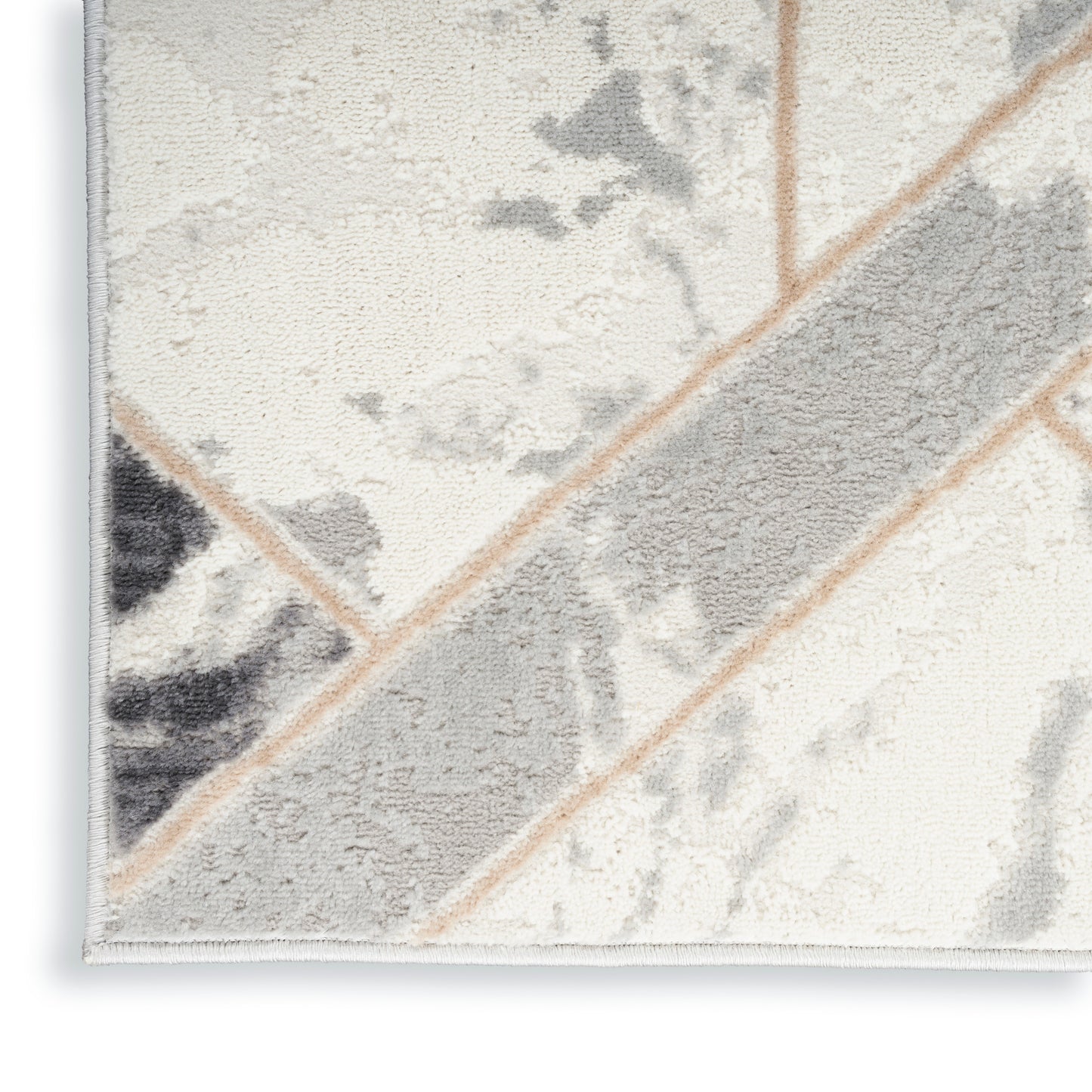 Corner close-up of a cream-gray abstract area rug with taupe diagonal bands and marble-like pattern; plush pile.