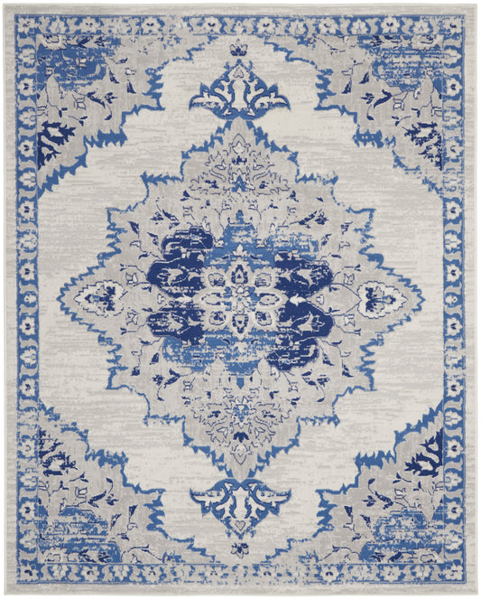 Blue and cream oriental area rug with distressed central medallion and floral border; rectangular vintage style.