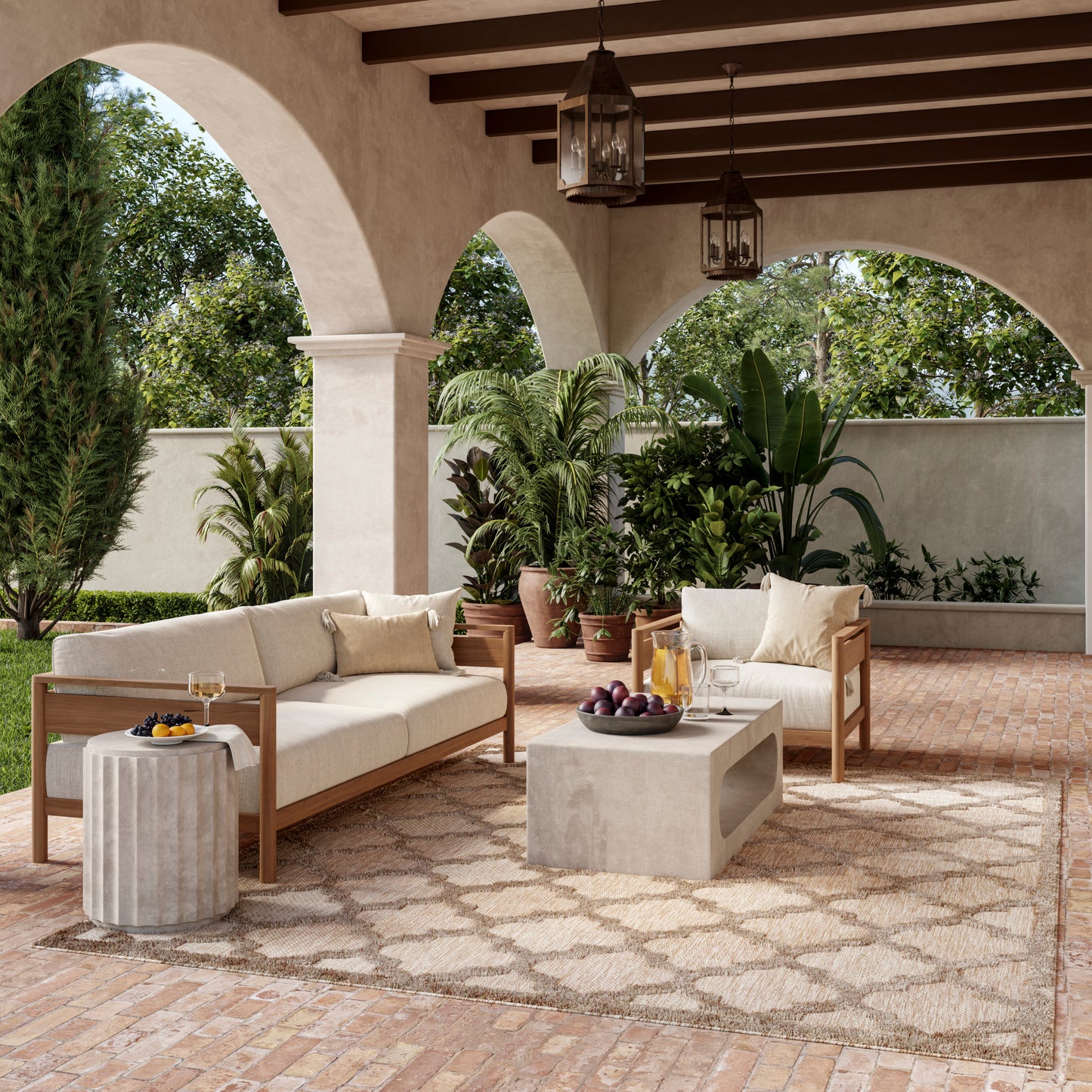Mediterranean outdoor lounge with beige cushioned wooden sofas, concrete coffee table, potted plants, arches and lanterns.
