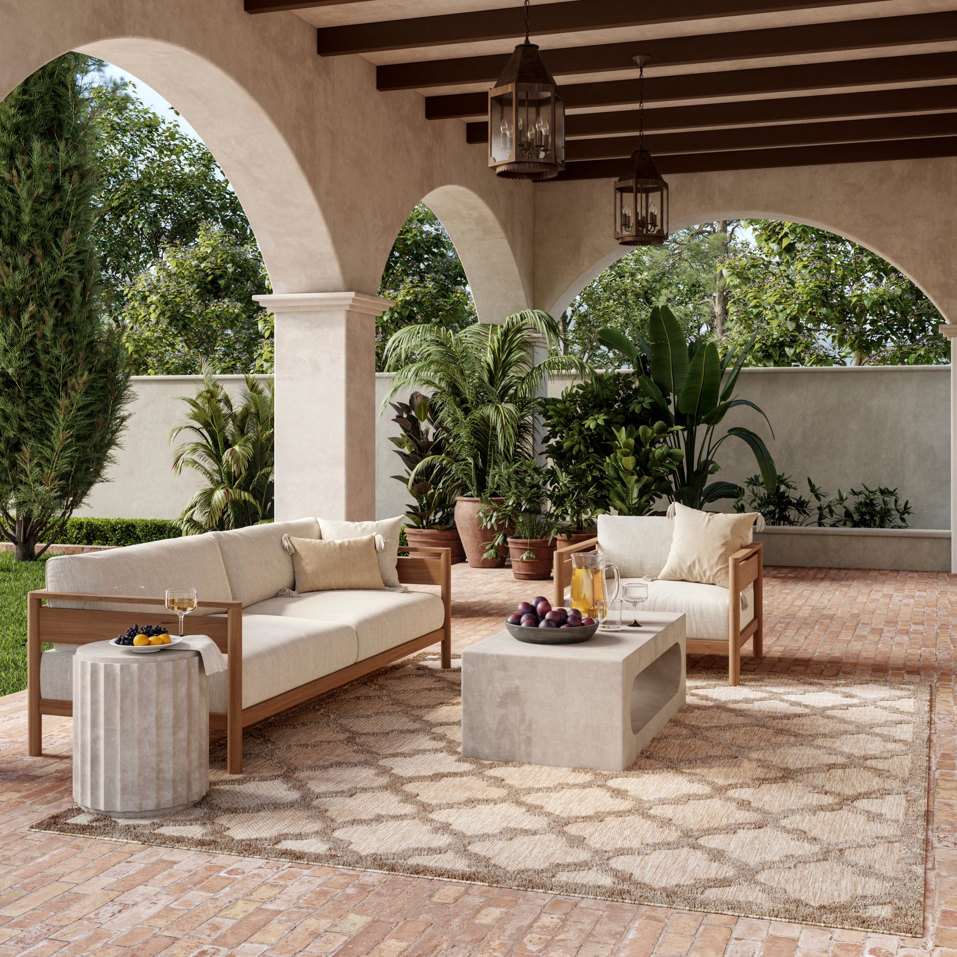 Mediterranean outdoor lounge with beige cushioned wooden sofas, concrete coffee table, potted plants, arches and lanterns.