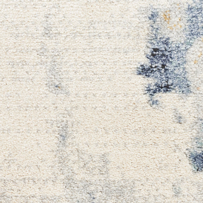 Cream shag rug with blue abstract patches; plush texture for cozy contemporary floor decor.