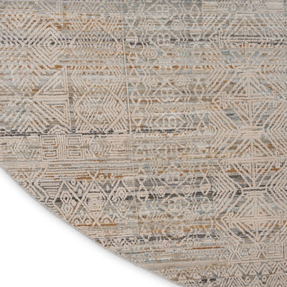 Round distressed area rug with geometric tribal pattern in beige, taupe, and blue-gray.