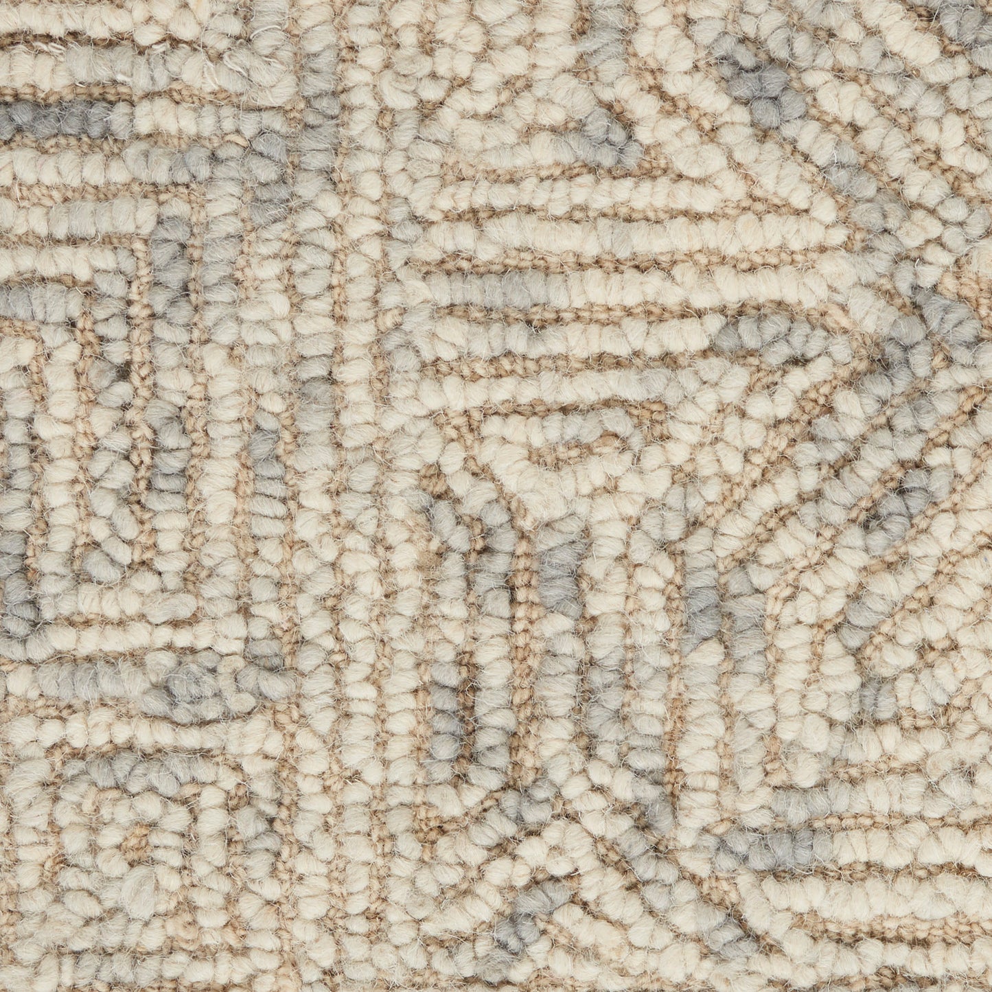 Close-up of a beige & gray geometric rug with looped, tufted pile & soft, textured surface.