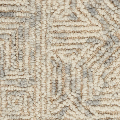 Close-up of a beige & gray geometric rug with looped, tufted pile & soft, textured surface.