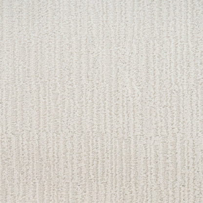 Cream-beige textured carpet with vertical loop pile pattern and soft plush feel.