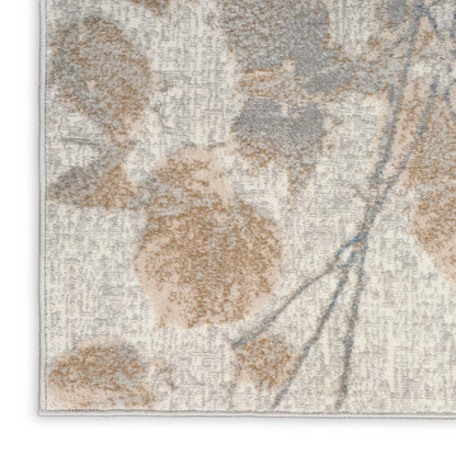 Textured beige rug with tan floral motifs, gray shading and subtle blue stems; rectangular, cozy home decor.