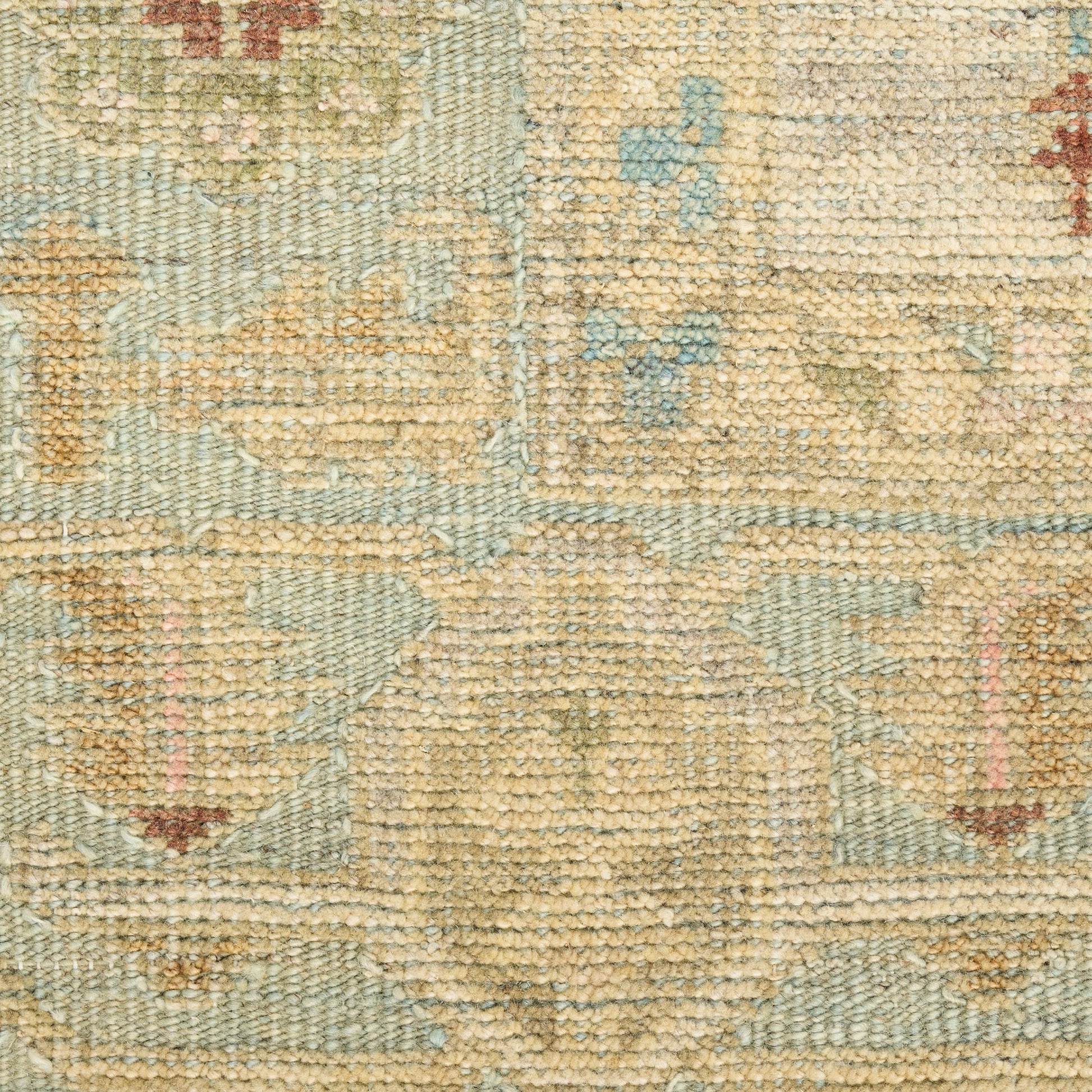 Beige and light blue woven rug with subtle floral medallion patterns; distressed look, soft pile for living room decor.