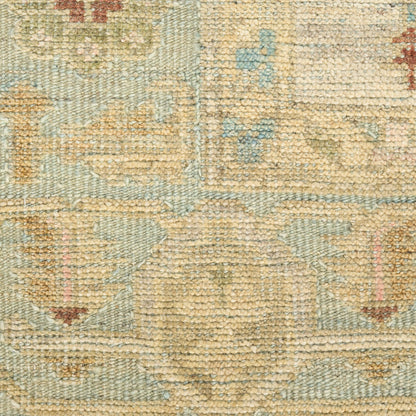 Beige and light blue woven rug with subtle floral medallion patterns; distressed look, soft pile for living room decor.