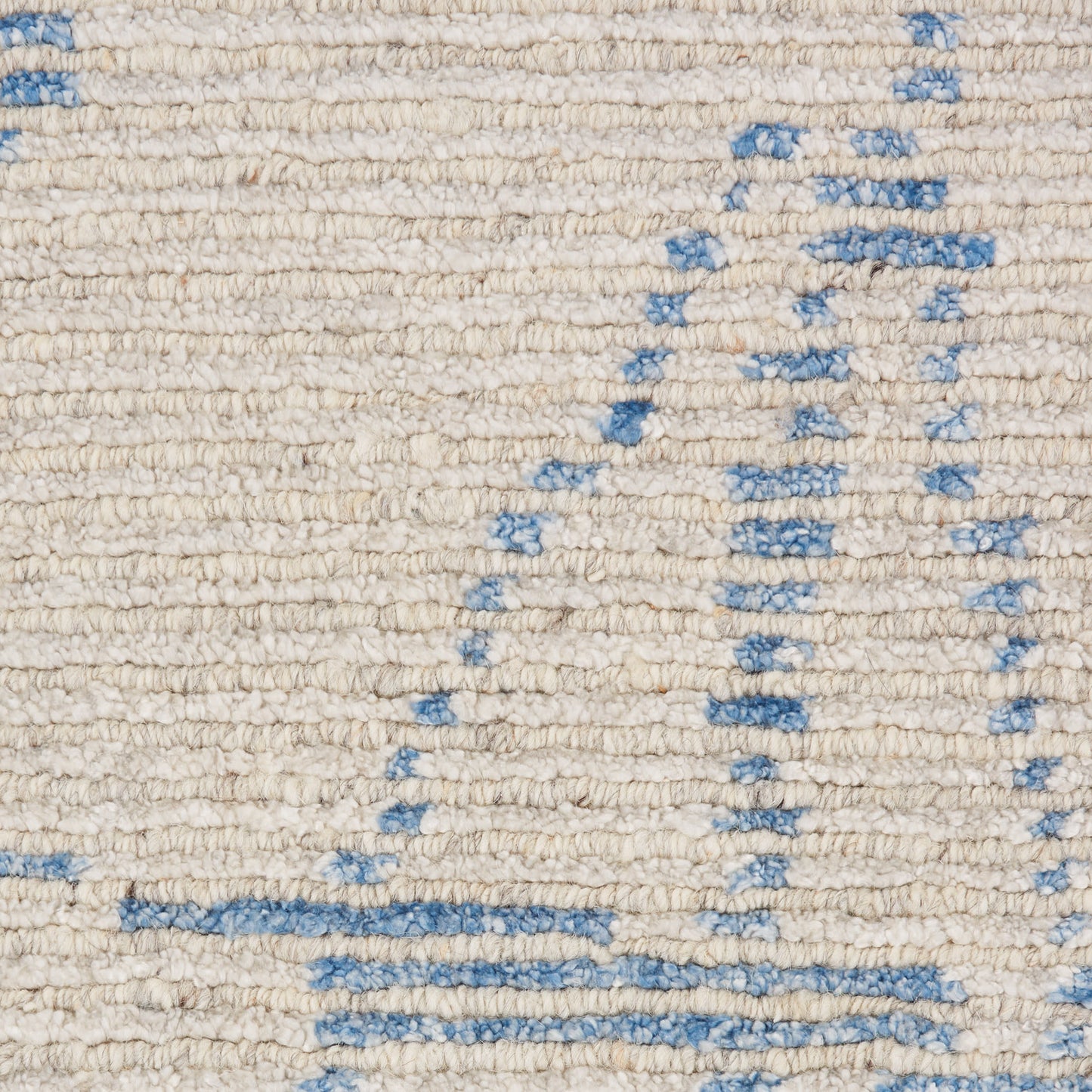 Cream textured woven rug with pale blue geometric lines and shapes.