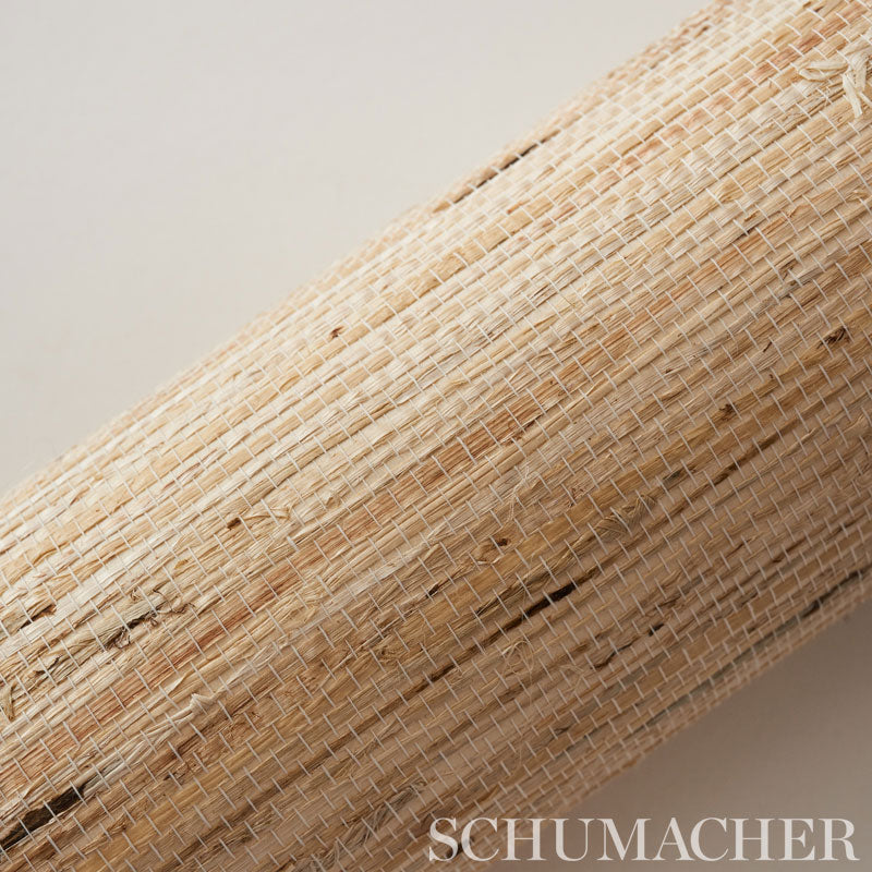 Natural woven straw mat roll in beige & tan fibers, rustic rattan texture.
