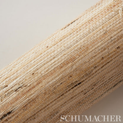 Natural woven straw mat roll in beige & tan fibers, rustic rattan texture.