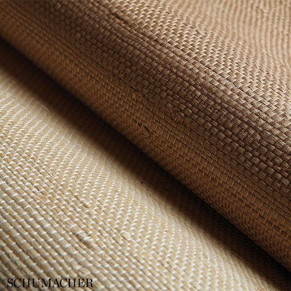 Natural beige basket-weave fabric close-up with diagonal fold; textured upholstery material.
