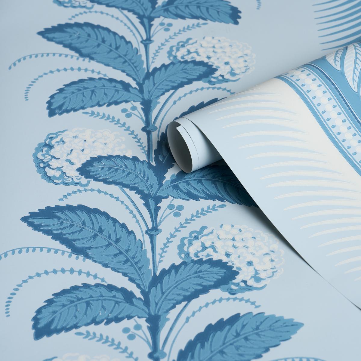 Schumacher Hydrangea Drape Wallpaper in Delft featuring large-scale hydrangea floral stripe design with ornate border in soft blue tones. Luxury designer wallpaper ideal for elegant interiors, dining rooms, bedrooms, hallways, powder rooms, and statement accent walls inspired by classic Hollywood decor.