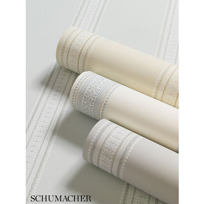 Three wallpaper rolls in limestone, cream and ivory with a Lorraine stripe pattern.