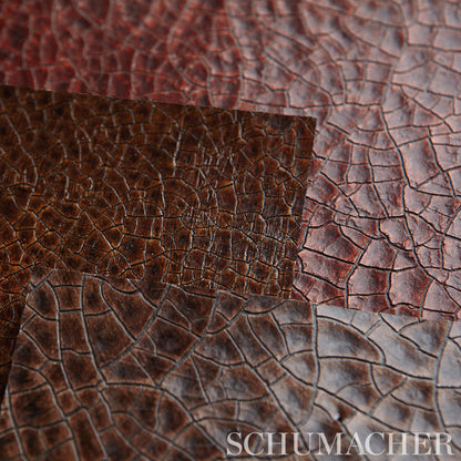Overlapping fabric swatches in red, dark brown and gray-blue, close-up texture.