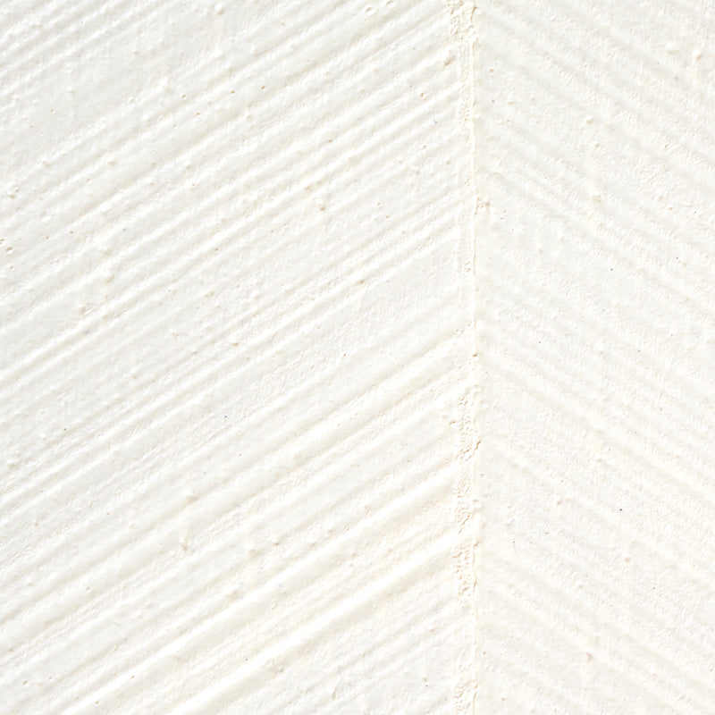 Close-up of ivory textured wallcovering with a combed chevron pattern and diagonal brushed texture.