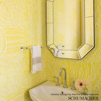 Yellow botanical wallpaper with hexagonal framed mirror, white sink, chrome faucet, towel bar, and light flower arrangement.
