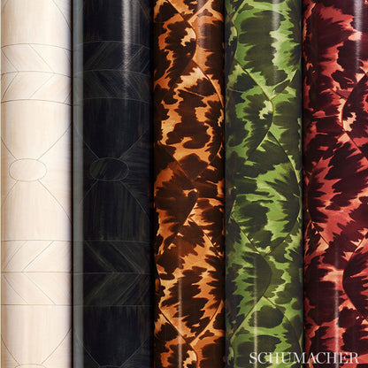 Vertical rolls of camouflage-pattern fabric in white, black, orange, green, and red hues.