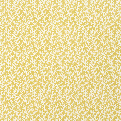 Mustard-yellow fabric with an irregular white speckle confetti-like pattern; abstract textile texture.