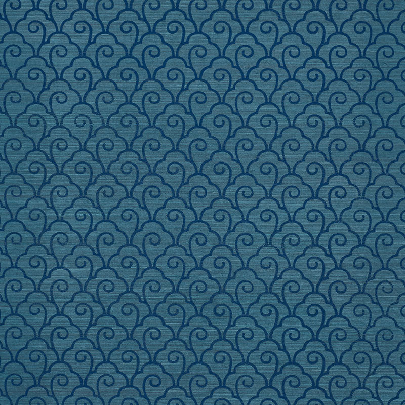Blue-teal repeating swirl-scroll scallop filigree pattern on a sisal rug; textured surface.