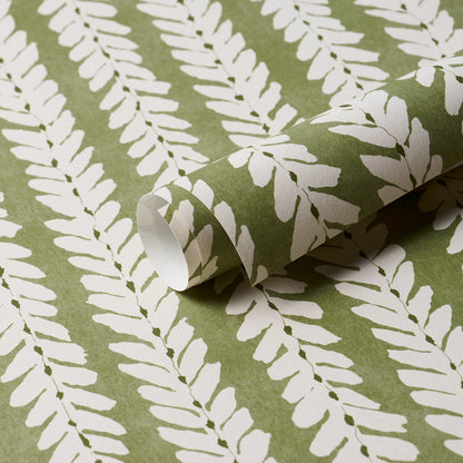 Olive green wallpaper with white fern leaf pattern, rolled sample; nature-inspired decorative wall covering.