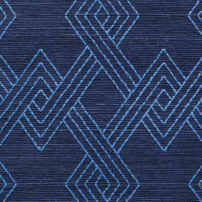 Dark navy textile with light blue stitched interlocking diamond pattern; geometric decorative rug.